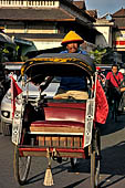 Riding the becak, the local cycle rickshaws in Malioboro street Yogyakarta. 